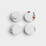 JONES + CO Hinoki shower steamers in a set of four round white tablets with dried botanical accents