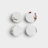 JONES + CO Hinoki shower steamers in a set of four round white tablets with dried botanical accents