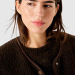 JONES + CO Hoktown sleeveless jacket in chestnut tree melange shearling fabric worn over a dark knit top