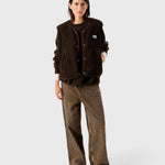 JONES + CO Hoktown sleeveless shearling jacket in chestnut tree melange worn by a model over a matching sweater