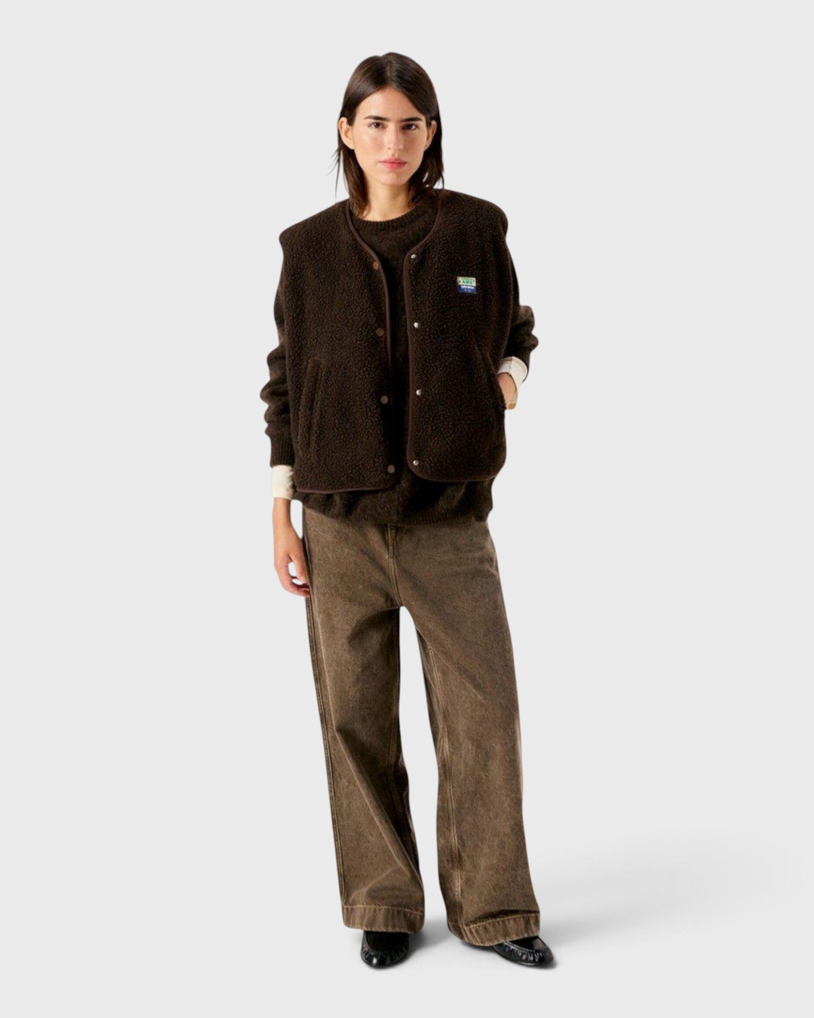 JONES + CO Hoktown sleeveless shearling jacket in chestnut tree melange worn by a model over a matching sweater