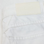 JONES + CO Jayla ivory white rigid denim jeans featuring a branded leather back patch and detailed stitching