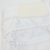 JONES + CO Jayla ivory white rigid denim jeans featuring a branded leather back patch and detailed stitching