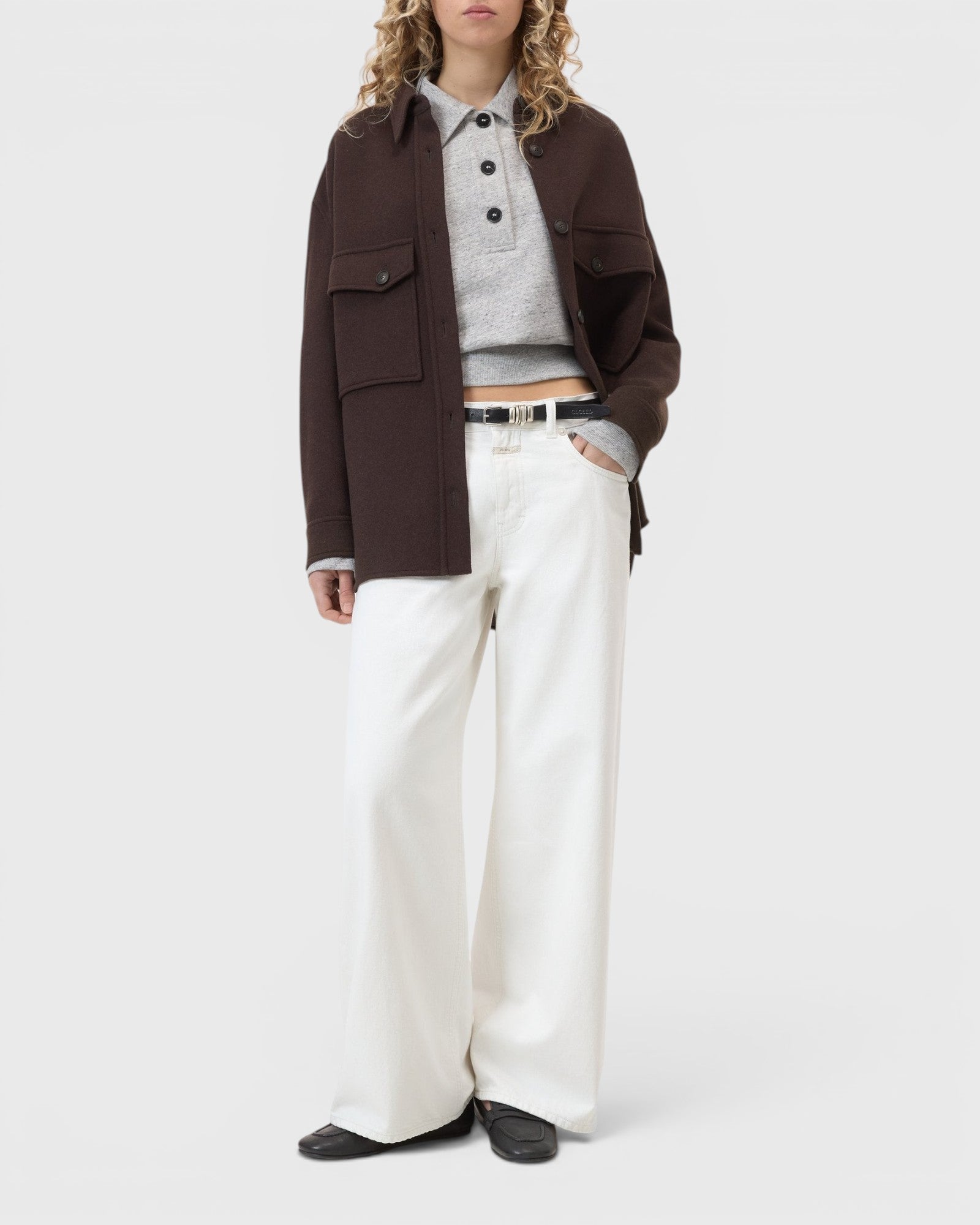 JONES + CO Jayla ivory white wide-leg rigid denim jeans worn by a model with a brown jacket and grey polo shirt