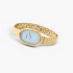 JONES + CO Jane watch featuring a 23mm oval gold case, sky blue mother-of-pearl dial, and gold-plated link bracelet.