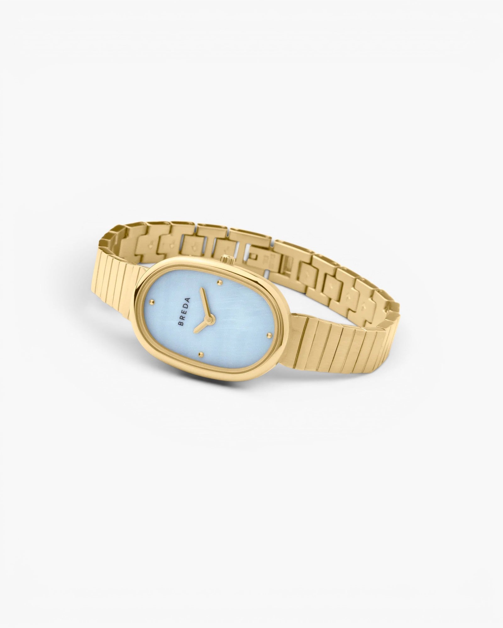 JONES + CO Jane watch featuring a 23mm oval gold case, sky blue mother-of-pearl dial, and gold-plated link bracelet.