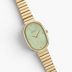 JONES + CO Jane watch with a gold-plated oval case, mint green dial, and matching gold stainless steel bracelet.