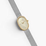 JONES + CO Jane Small Tethered watch with a gold oval case, champagne mother of pearl dial, and silver mesh bracelet.