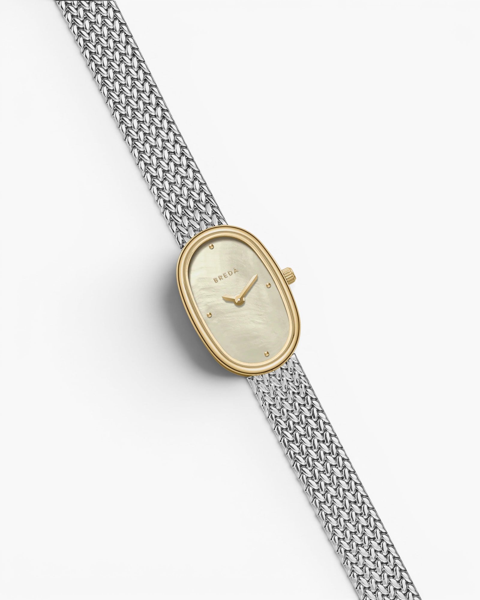 JONES + CO Jane Small Tethered watch with a gold oval case, champagne mother of pearl dial, and silver mesh bracelet.