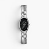 JONES + CO Jane Small Tethered watch with a silver woven mesh bracelet and a black oval dial.