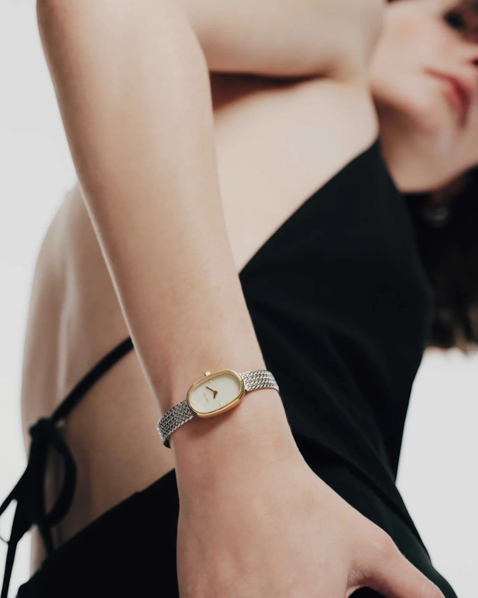 JONES + CO Jane Small watch with a gold and silver woven mesh bracelet and champagne mother of pearl oval dial