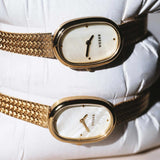 JONES + CO Jane Tethered watch featuring a 23mm oval gold case, champagne mother-of-pearl dial, and woven mesh bracelet.