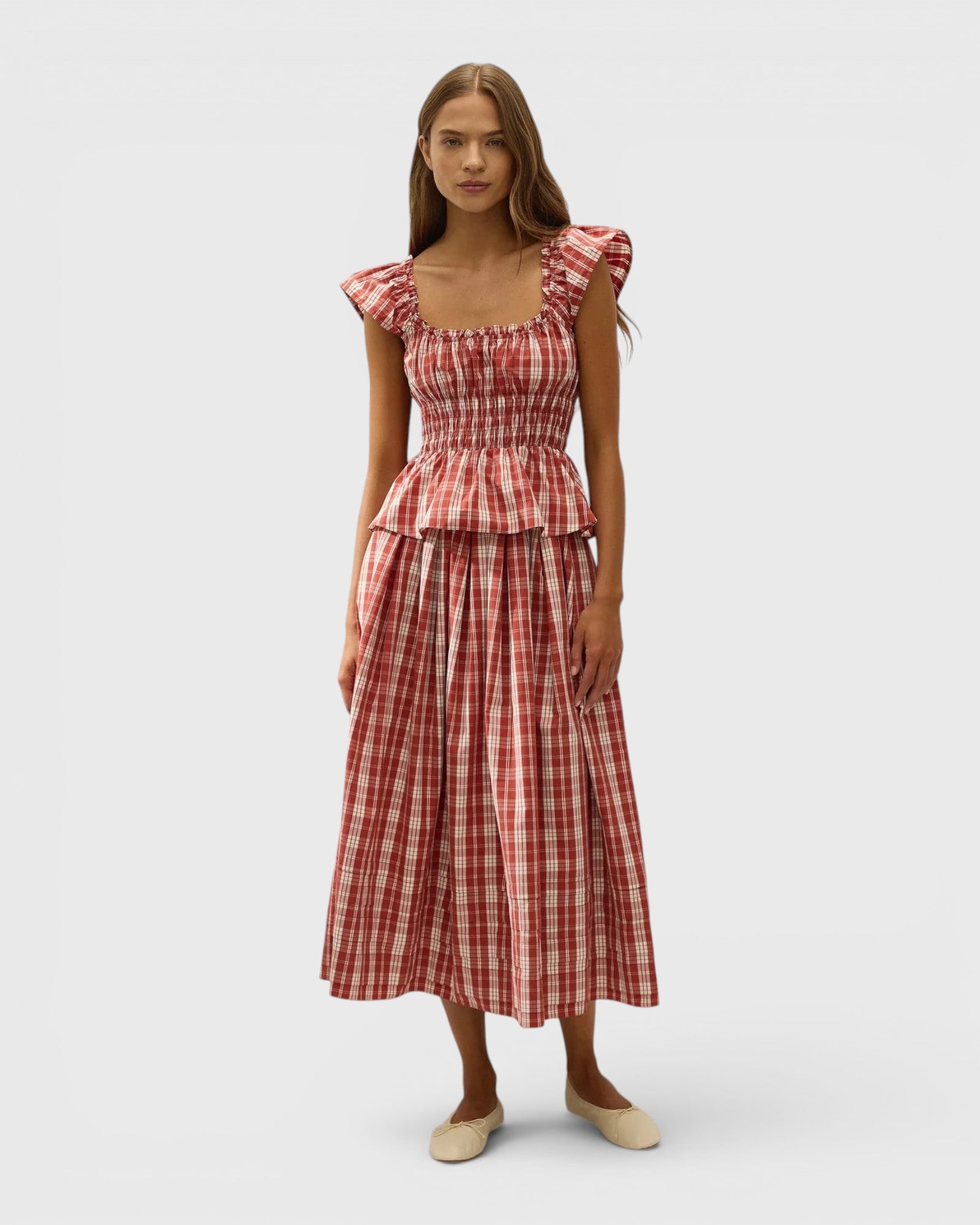 JONES + CO Janne top in terra rosso check with square neckline, frilled cap sleeves, and shirred waist on a model