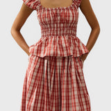 JONES + CO Janne top in terra rosso check with square neckline, cap sleeves, and shirred waist on a model