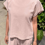 JONES + CO Jeanne muscle tee in baby pink with a high crew neck and dolman sleeves, worn with matching shorts.