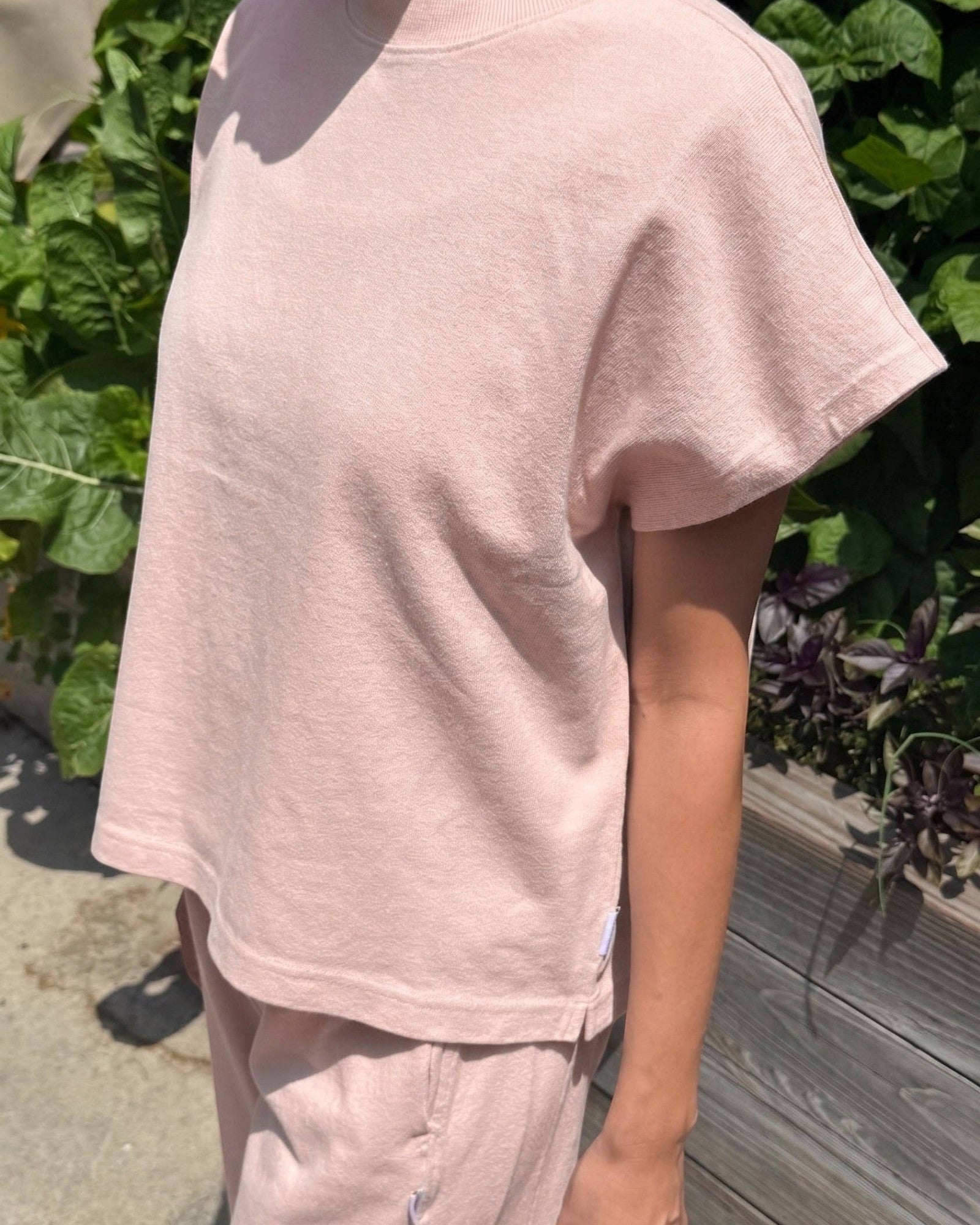 JONES + CO Jeanne muscle tee in baby pink with a high crew neck, wide neckband, and dolman sleeves.