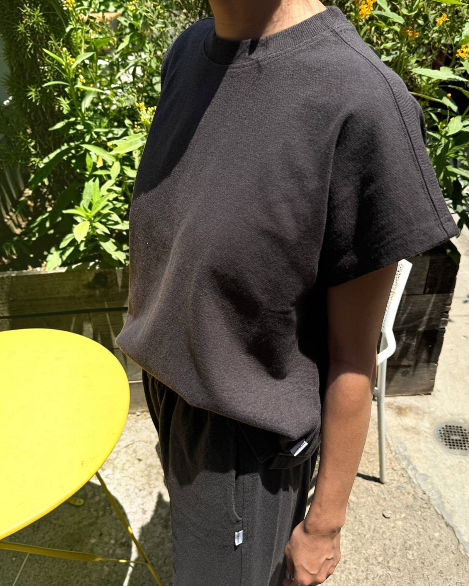 JONES + CO Jeanne muscle tee in dark slate with a high crew neck and dolman sleeves worn outdoors.