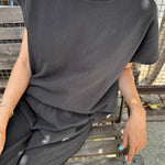 JONES + CO Jeanne muscle tee in dark slate with dolman sleeves and a wide crew neckband worn with matching bottoms.