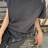JONES + CO Jeanne muscle tee in dark slate with dolman sleeves and a wide crew neckband worn with matching bottoms.