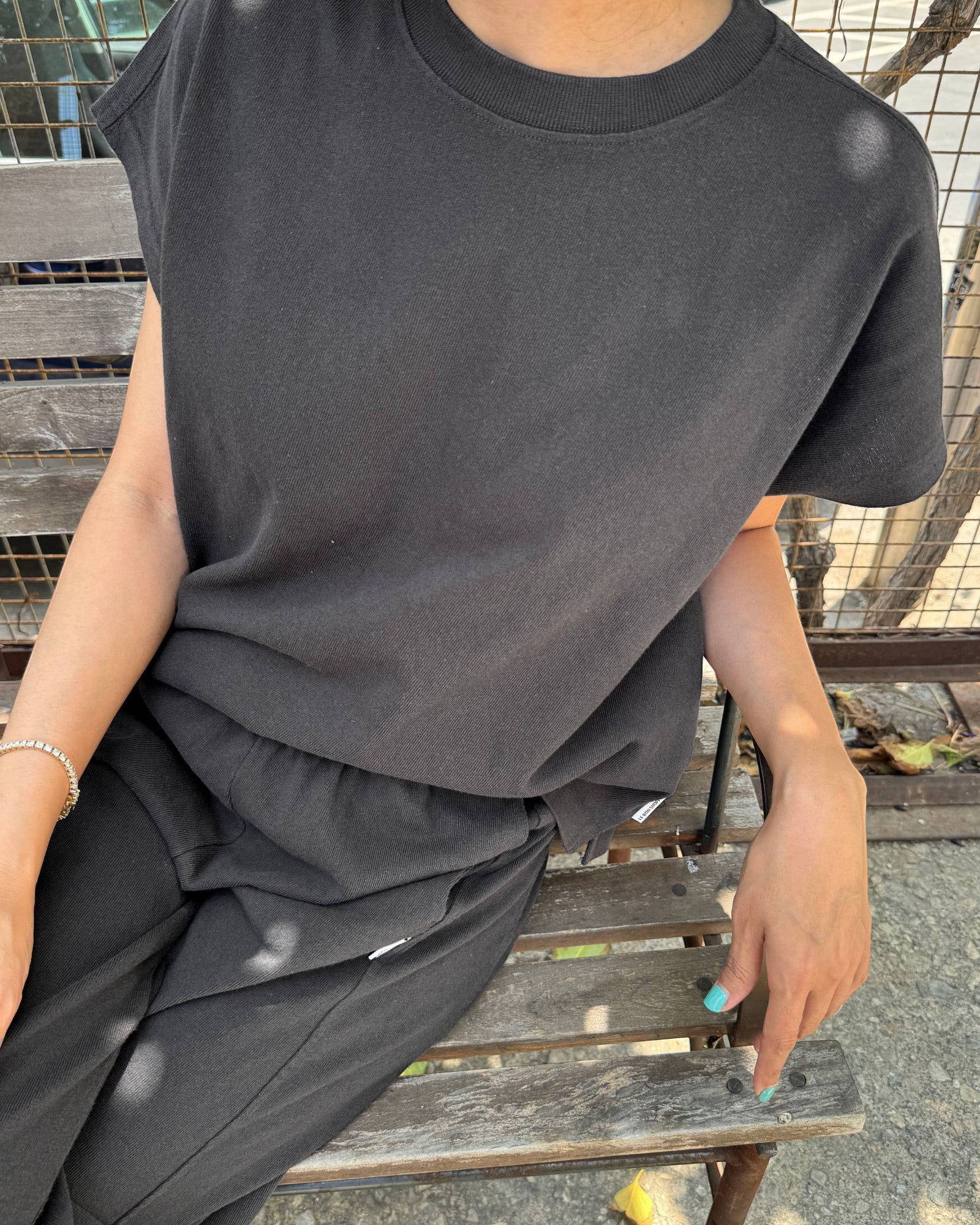 JONES + CO Jeanne muscle tee in dark slate with dolman sleeves and a wide crew neckband worn with matching bottoms.