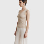 JONES + CO Kana Tank in dune beige featuring a deep scoop neckline and finely ribbed knit fabric on a model
