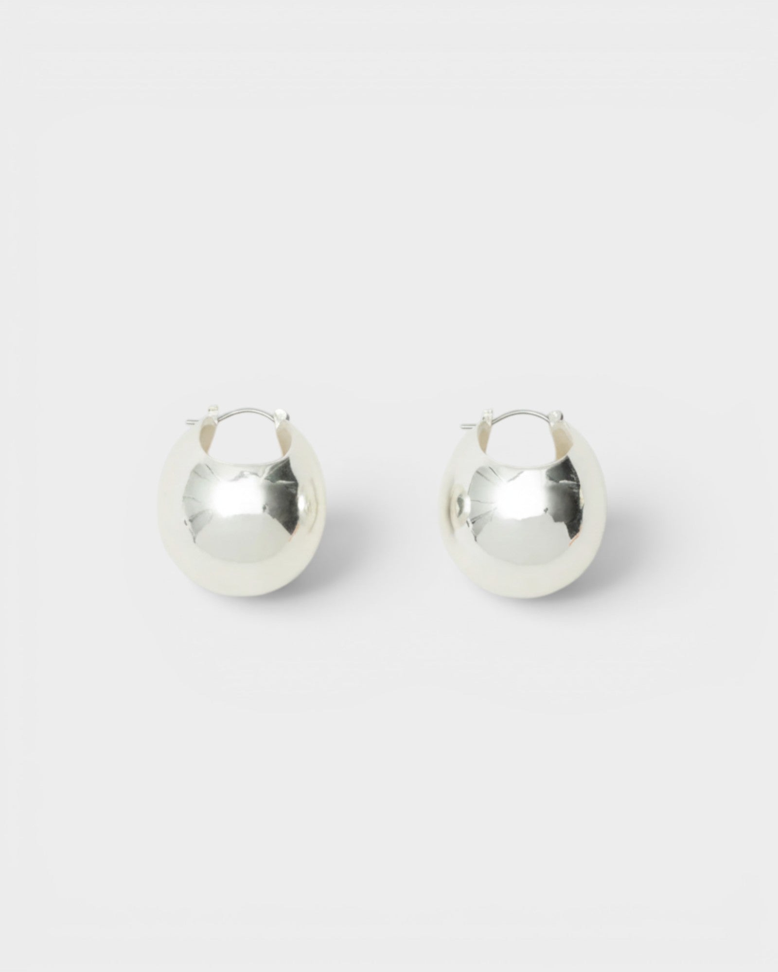 JONES + CO large silver hollow oblong hoop earrings with hinged fastening for pierced ears.