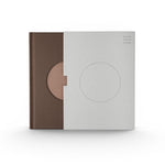 JONES + CO Open Journal with a brown fabric cover and a grey slipcase featuring a circular cutout design.