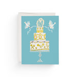 JONES + CO Love Cake wedding greeting card featuring a tiered cake illustration with doves on a blue background