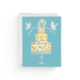 JONES + CO Love Cake wedding greeting card featuring a tiered cake illustration with doves on a blue background