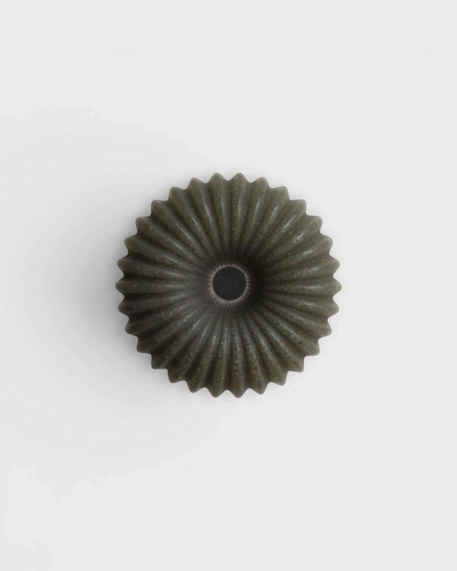 JONES + CO lülala lavender and pink grapefruit soap bar with a unique circular, ribbed, and textured green design.