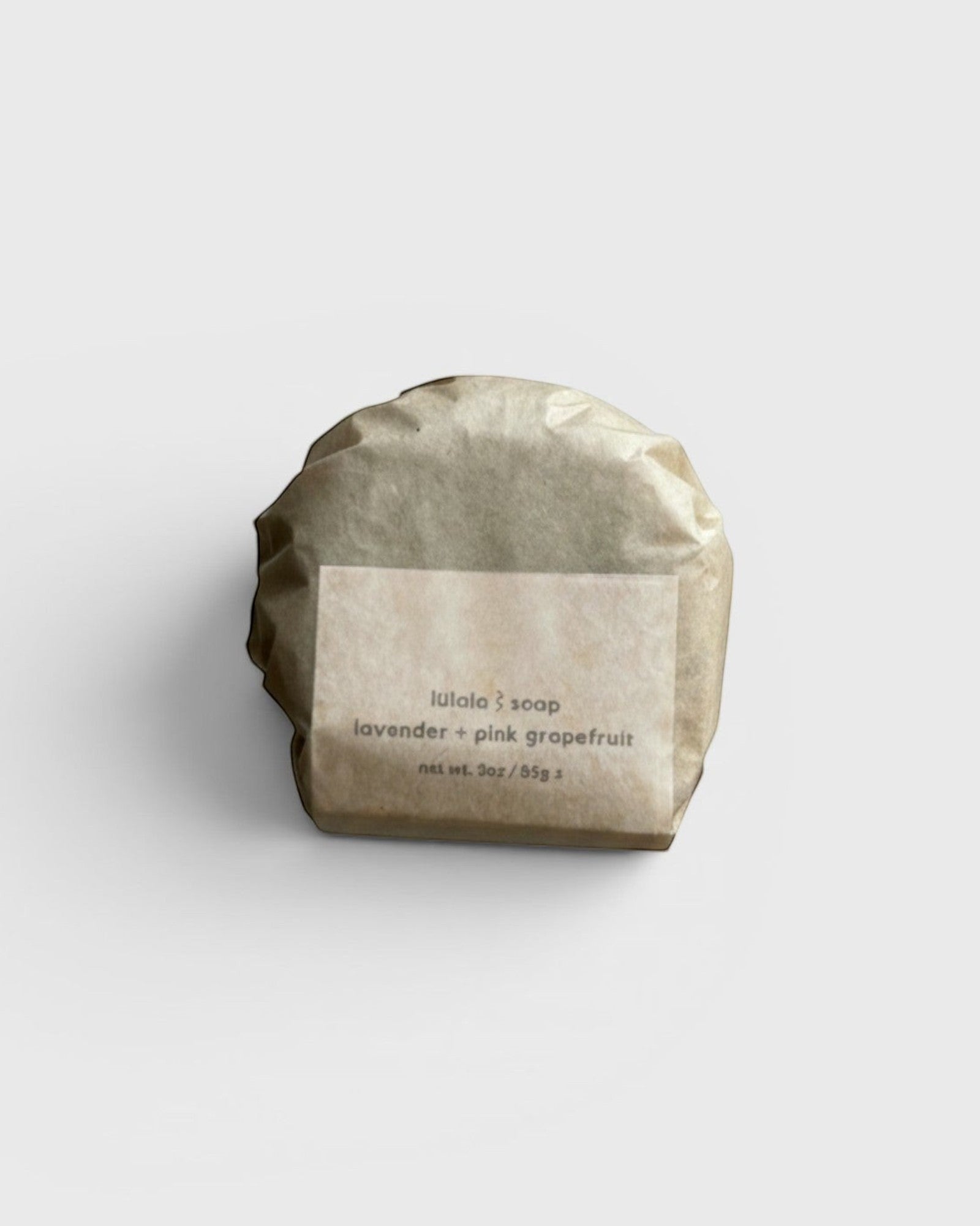 JONES + CO lülala lavender and pink grapefruit soap bar wrapped in sustainable brown paper packaging.