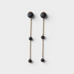 JONES + CO Morse long drop earrings in matte black with brass chain links and resin beads.