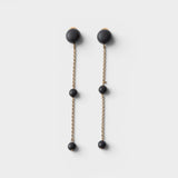 JONES + CO Morse long drop earrings in matte black with brass chain links and resin beads.