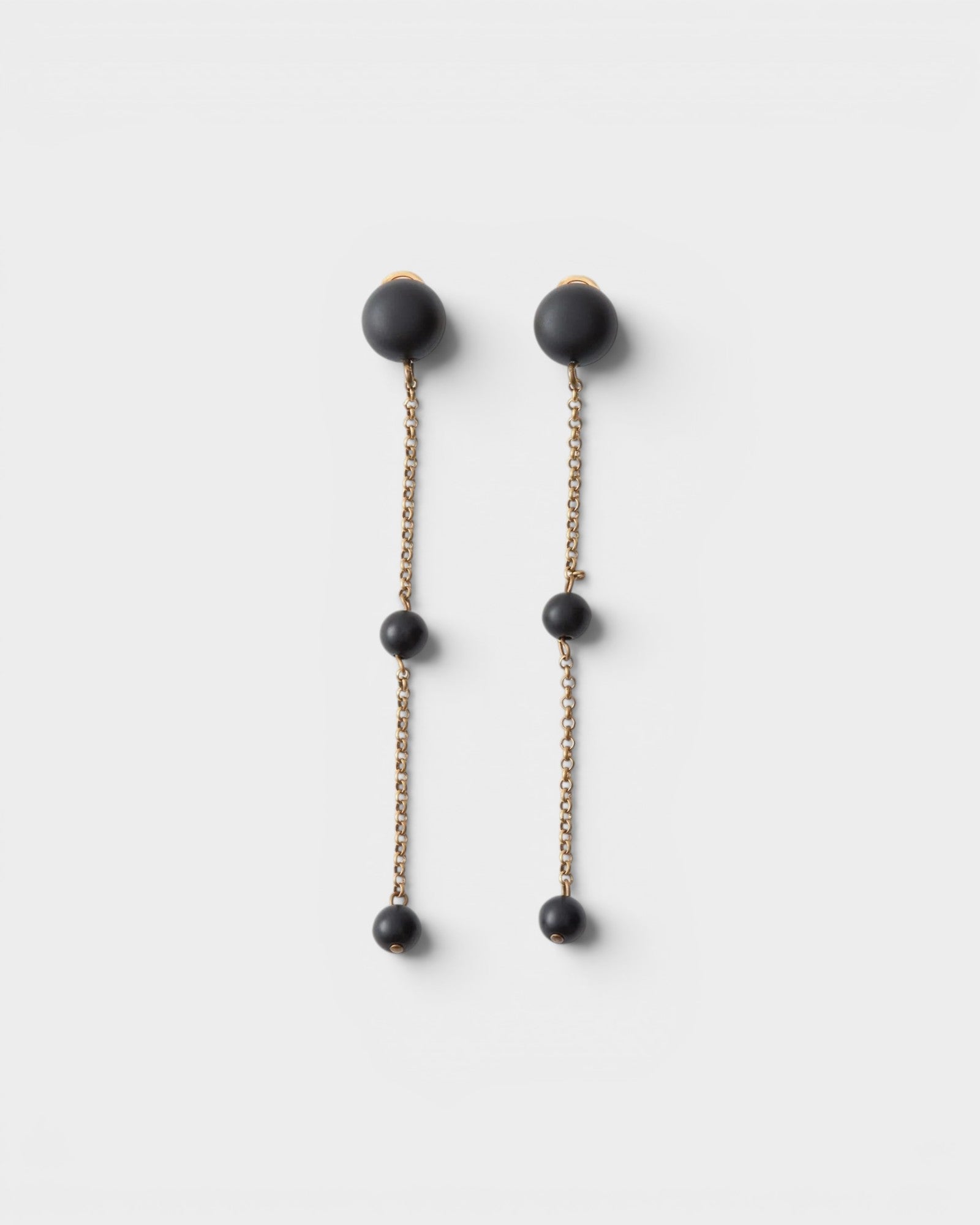 JONES + CO Morse long drop earrings in matte black with brass chain links and resin beads.