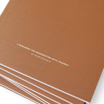 JONES + CO Me-est Me Journal with a terracotta brown cover and white minimalist typography on a white background.