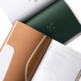 JONES + CO Me-est Me Journal open to pages with organic shapes, calming earth tones, and guided self-reflection prompts.