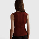 Back view of a model wearing the JONES + CO Kana Tank in merlot, featuring a ribbed knit and central seam detail.