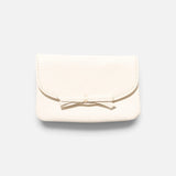 JONES + CO milk pebble grain leather petite case featuring a delicate knotted bow on the front flap