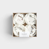 JONES + CO mini shower steamer set featuring four assorted aromatherapy tablets with dried floral botanicals in a box
