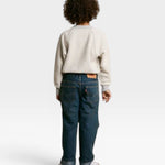 JONES + CO Mini Ziggy sweatshirt in heather grey soft cotton fleece worn by a child with blue jeans from behind