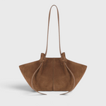 JONES + CO Mochi tote bag in cognac Italian suede featuring organic curves, knotted details, and a long shoulder strap.