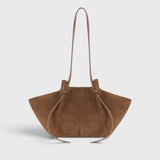 JONES + CO Mochi tote bag in cognac Italian suede featuring organic curves, knotted details, and a long shoulder strap.
