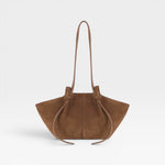JONES + CO Mochi tote bag in cognac Italian suede featuring organic curves, knotted details, and a long shoulder strap.