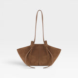 JONES + CO Mochi tote bag in cognac Italian suede featuring organic curves, knotted details, and a long shoulder strap.