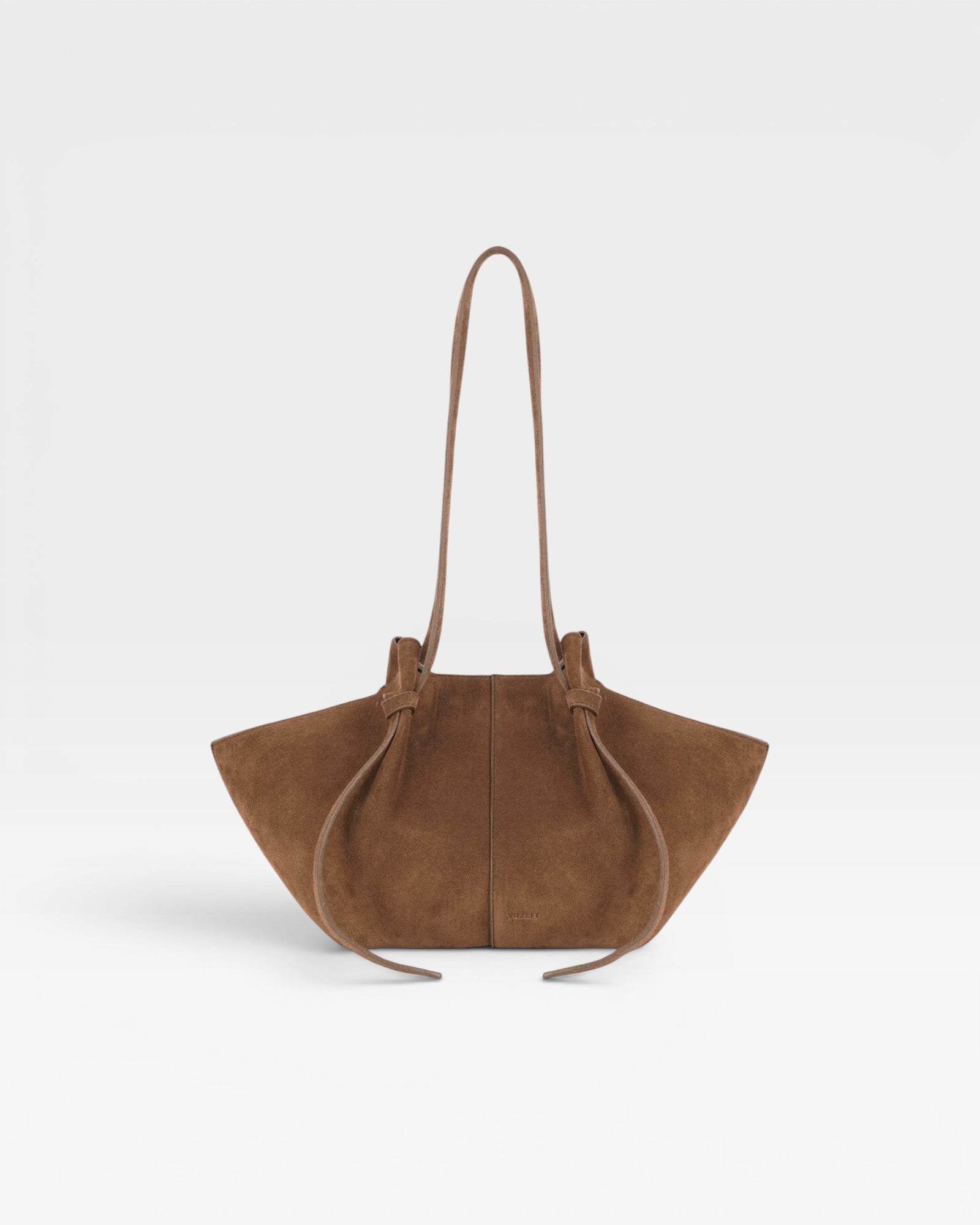JONES + CO Mochi tote bag in cognac Italian suede featuring organic curves, knotted details, and a long shoulder strap.