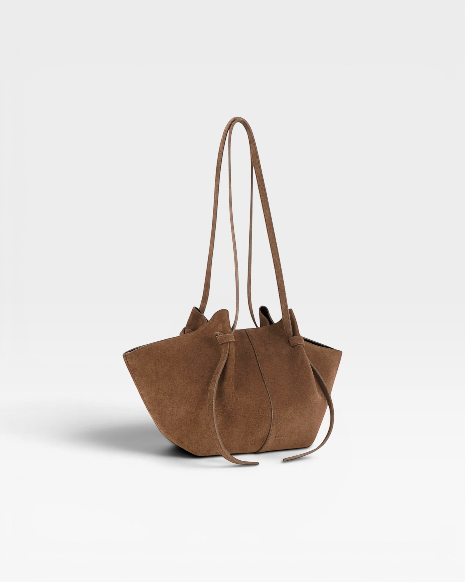 JONES + CO Mochi tote bag in cognac Italian suede featuring organic curves, folds, and knotted shoulder straps.