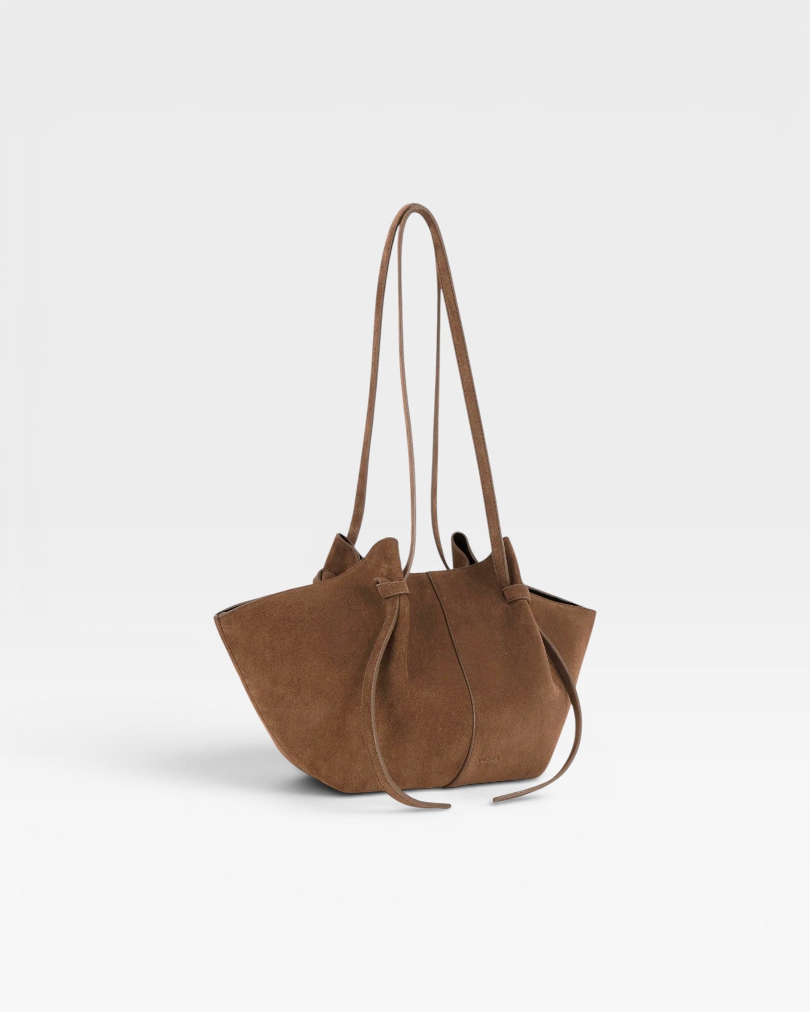 JONES + CO Mochi tote bag in cognac Italian suede featuring organic curves, folds, and knotted shoulder straps.