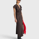 JONES + CO  apiece apart Monde Drape Bias Maxi dress in black coffee featuring a V-neck, front zip, and fluid viscose blend fabric.