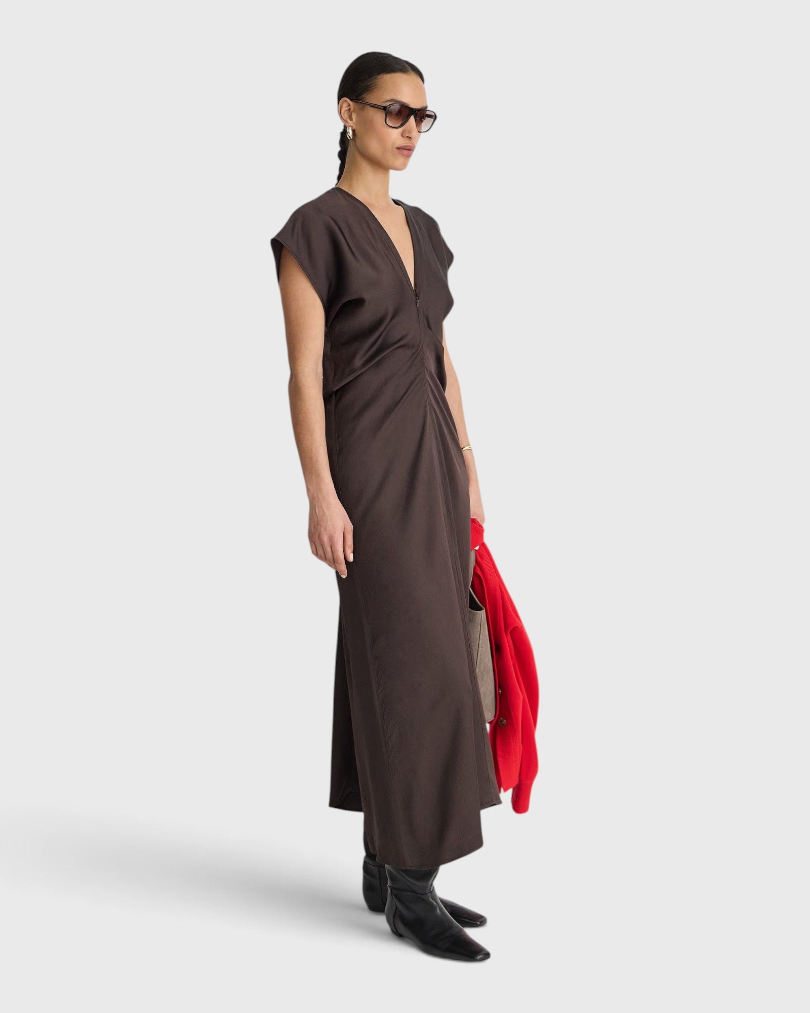 JONES + CO  apiece apart Monde Drape Bias Maxi dress in black coffee featuring a V-neck, front zip, and fluid viscose blend fabric.