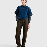 JONES + CO Fort Top in muddy indigo denim worn over a patterned shirt and brown trousers by a model
